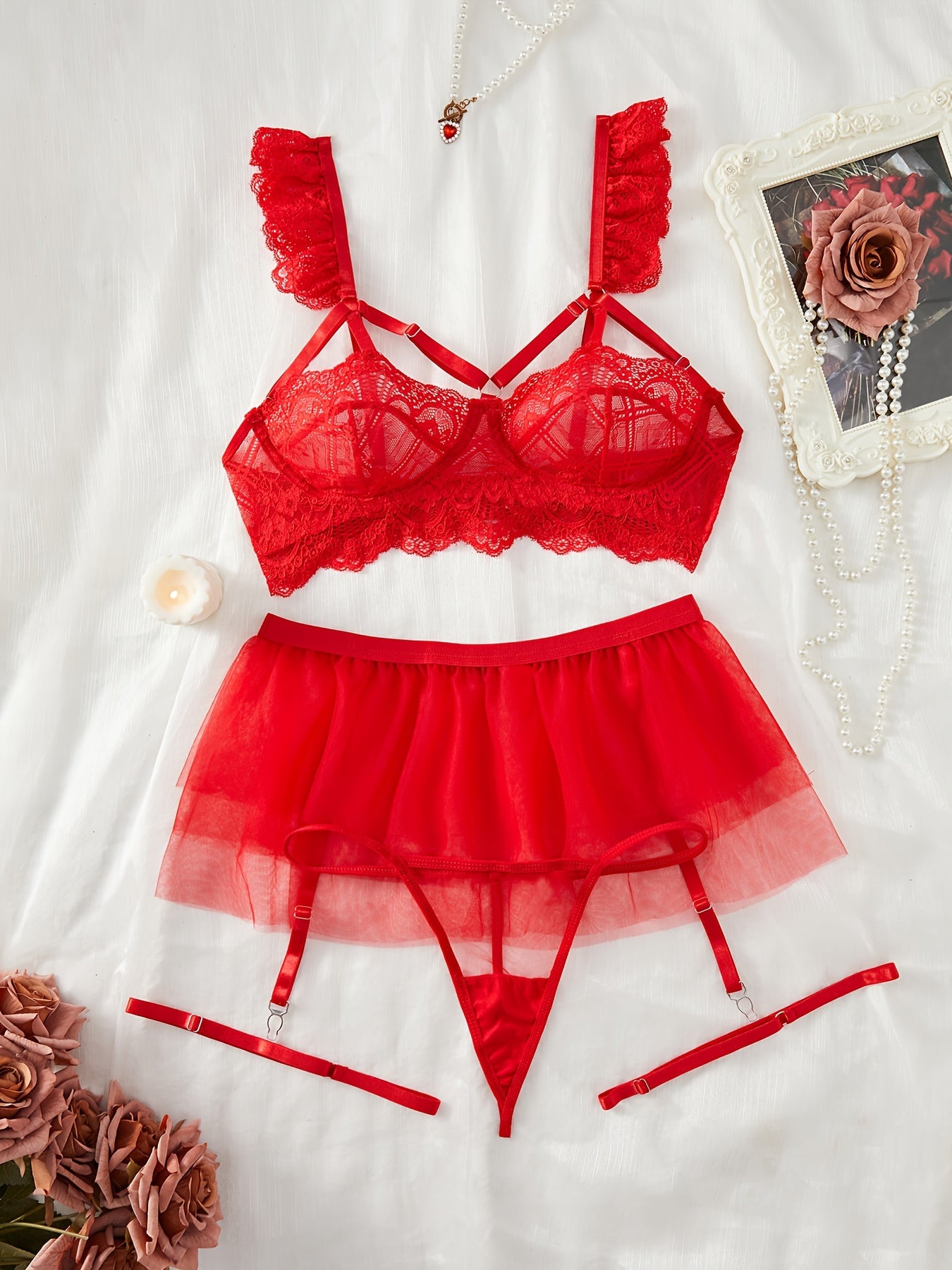 Red lace lingerie set with adjustable straps, mesh underwear, garter belt skirt, and leg garters, perfect for the bedroom.