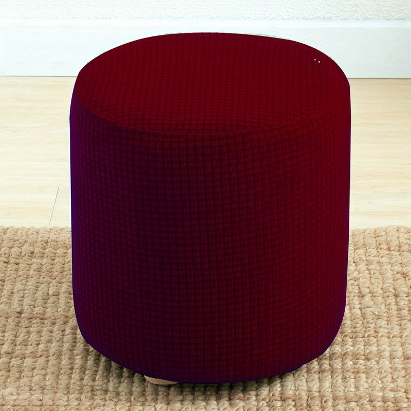 Stretchable round footstool cover made from soft polyester blend with elastic fit. Available in multiple colors, machine washable, modern design for living room ottomans.