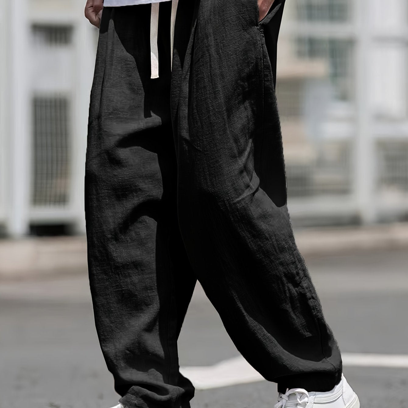 Street style drawstring trousers for men with a loose fit.