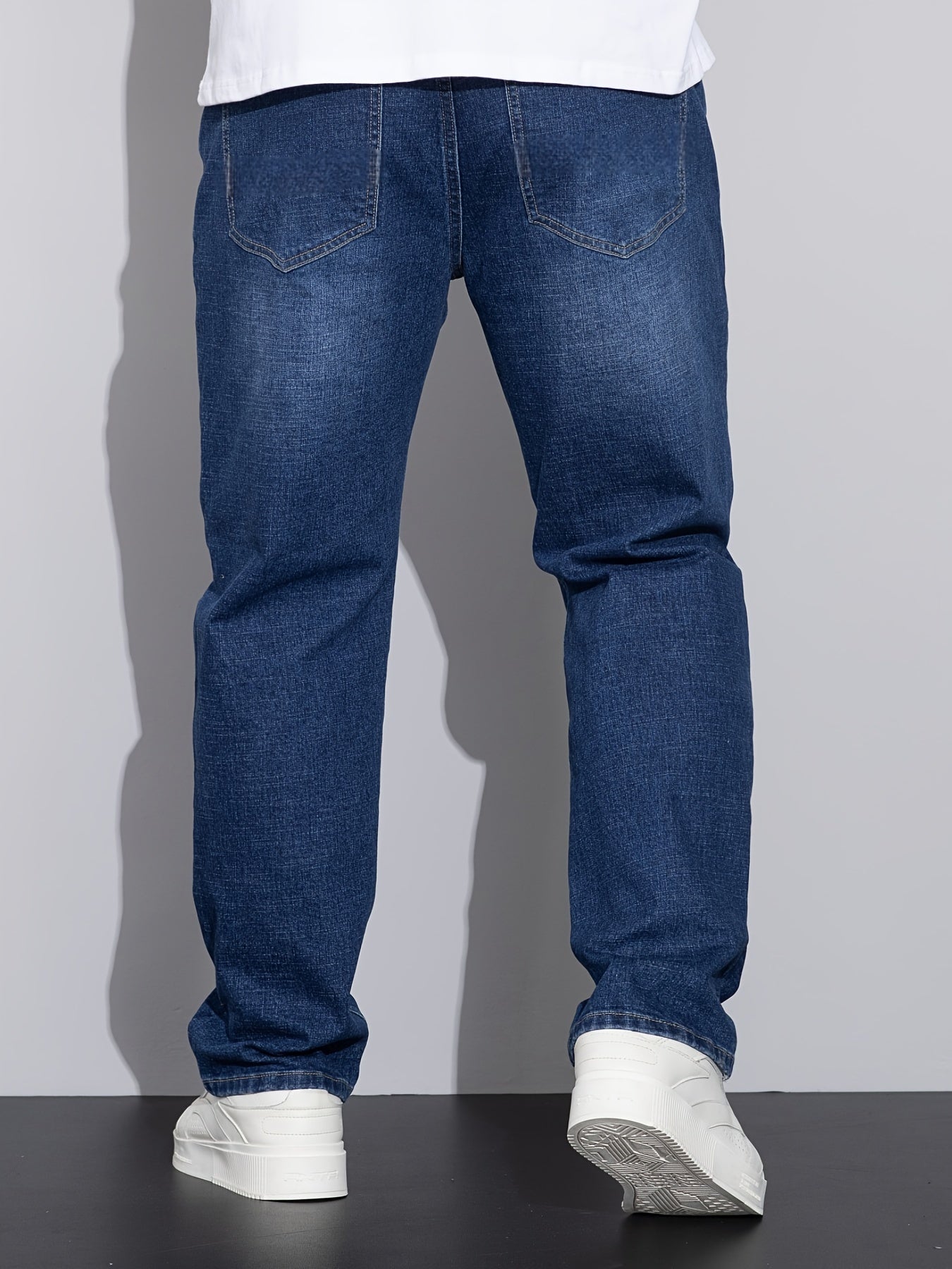 Men's stretchy cotton denim pants for all seasons, in a loose fit and plus size, perfect for business casual wear.