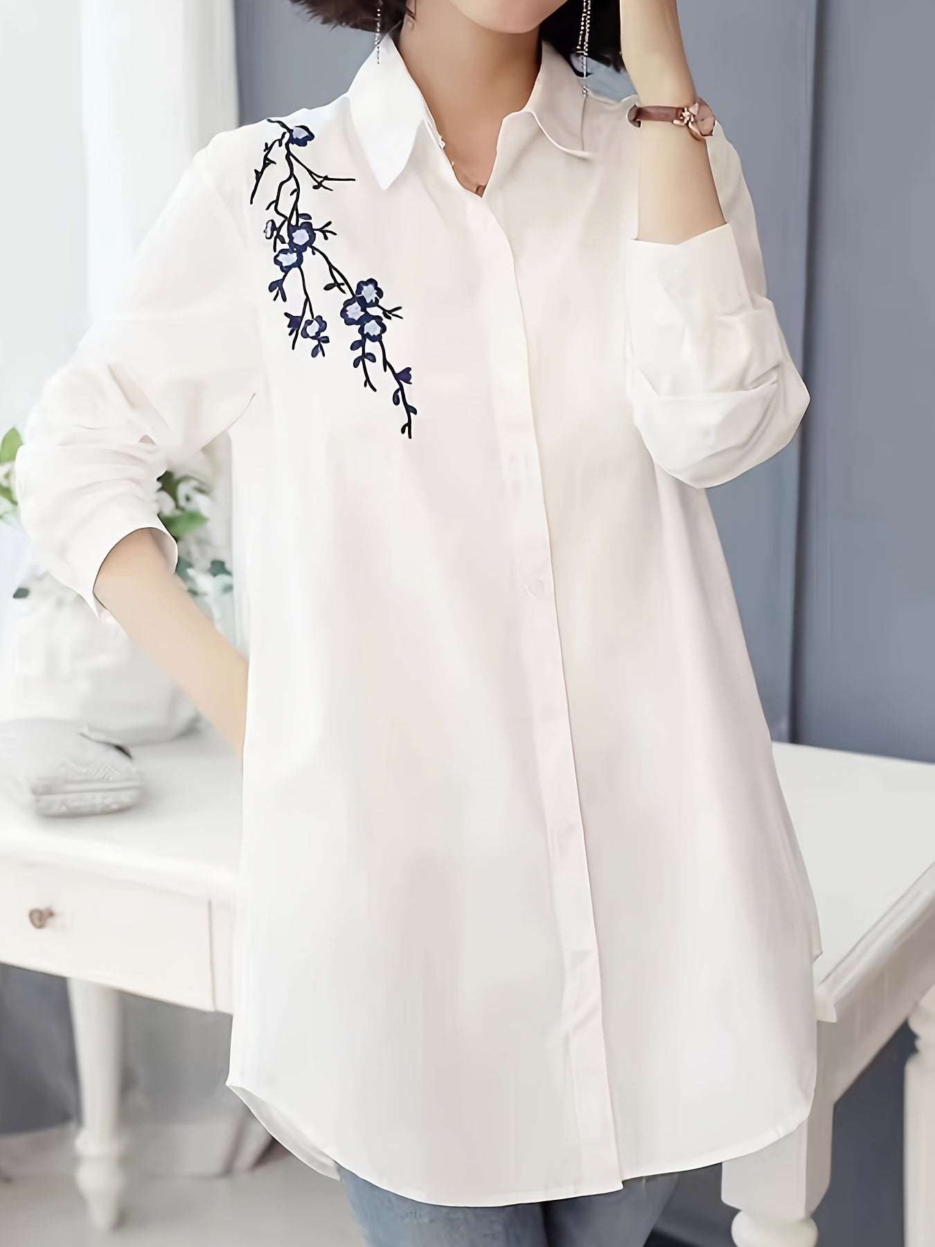 Stylish white polyester blouse with floral design, collared and machine washable for women; perfect for spring, summer, and fall.