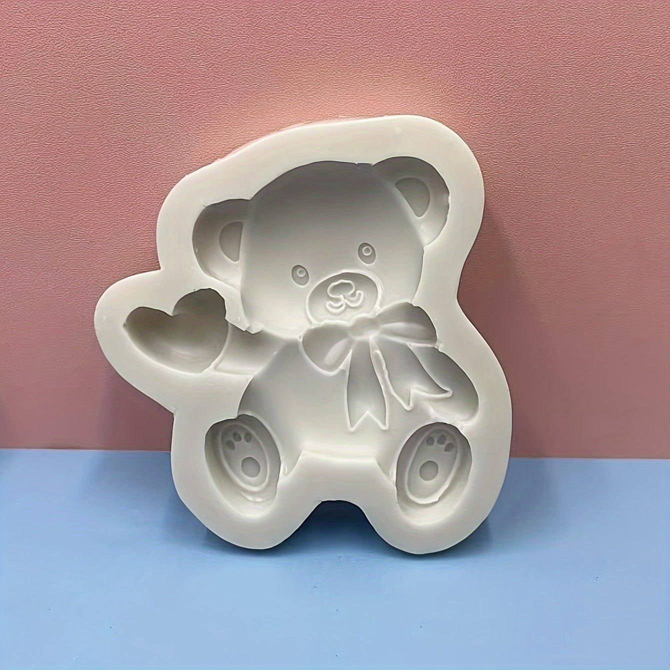 Silicone mold featuring a cute bear with a heart shape design, ideal for making mousse, fondant cakes, chocolates, and biscuits in the kitchen. This versatile tool can also be used for handmade candies, jellies, and puddings, as well as for creating drop