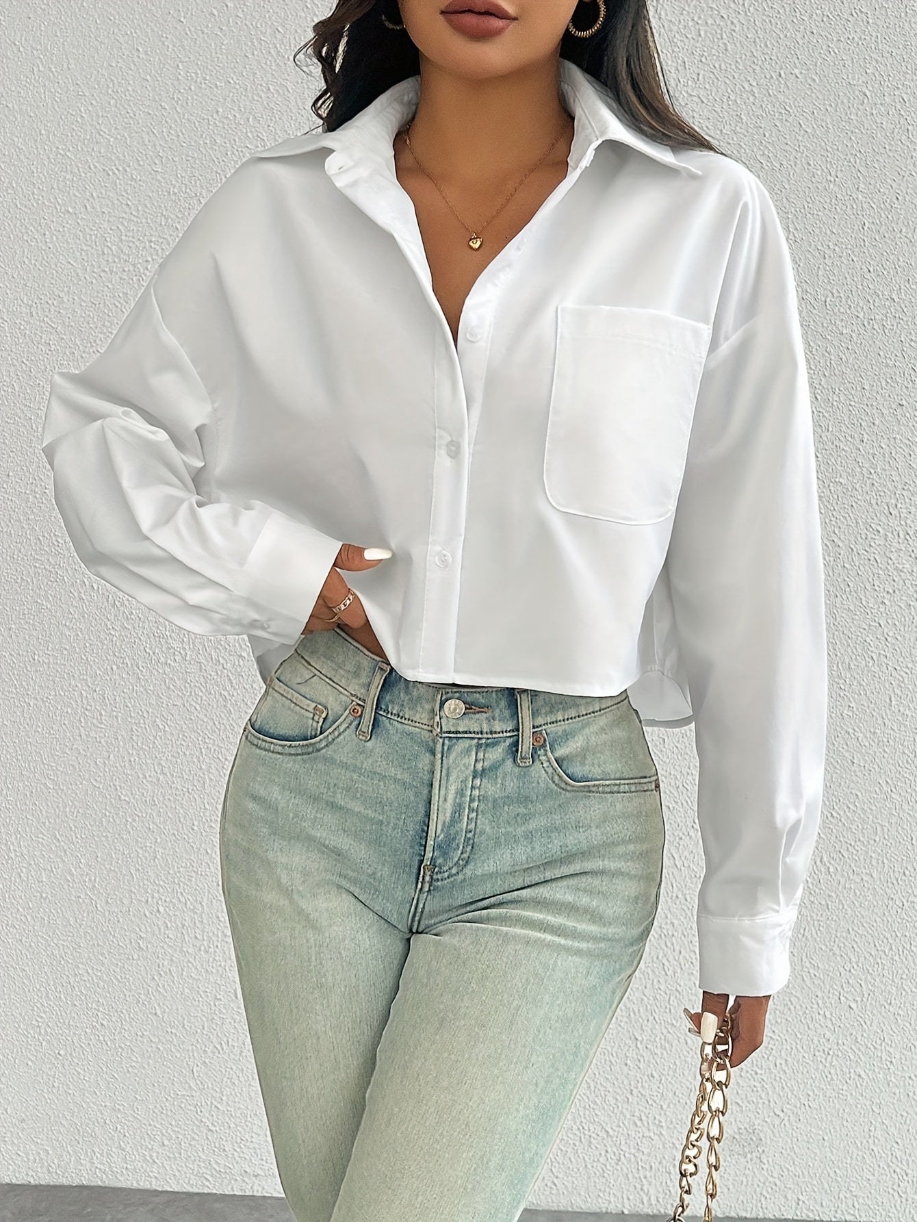 Stylish white casual shirt for women, drop shoulder, long sleeve, short style with pocket, button-up, made of 100% polyester, machine washable, ideal for casual wear.