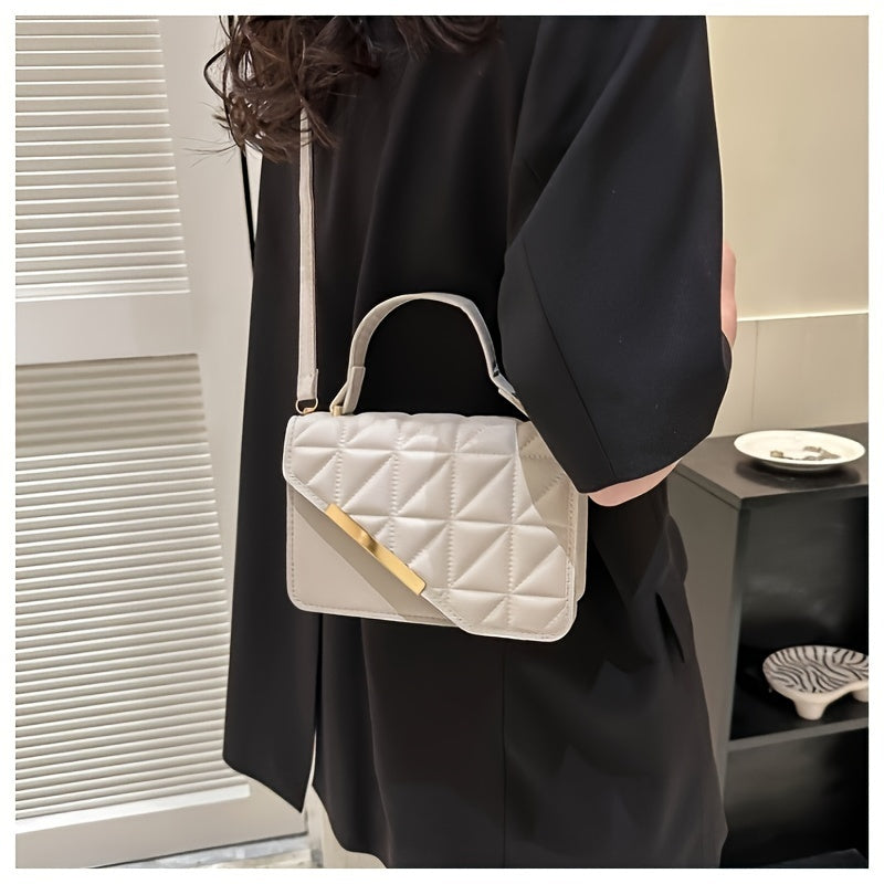 Chic black quilted crossbody bag with detachable strap, diamond stitching, golden-tone plaque. Versatile design for everyday use.