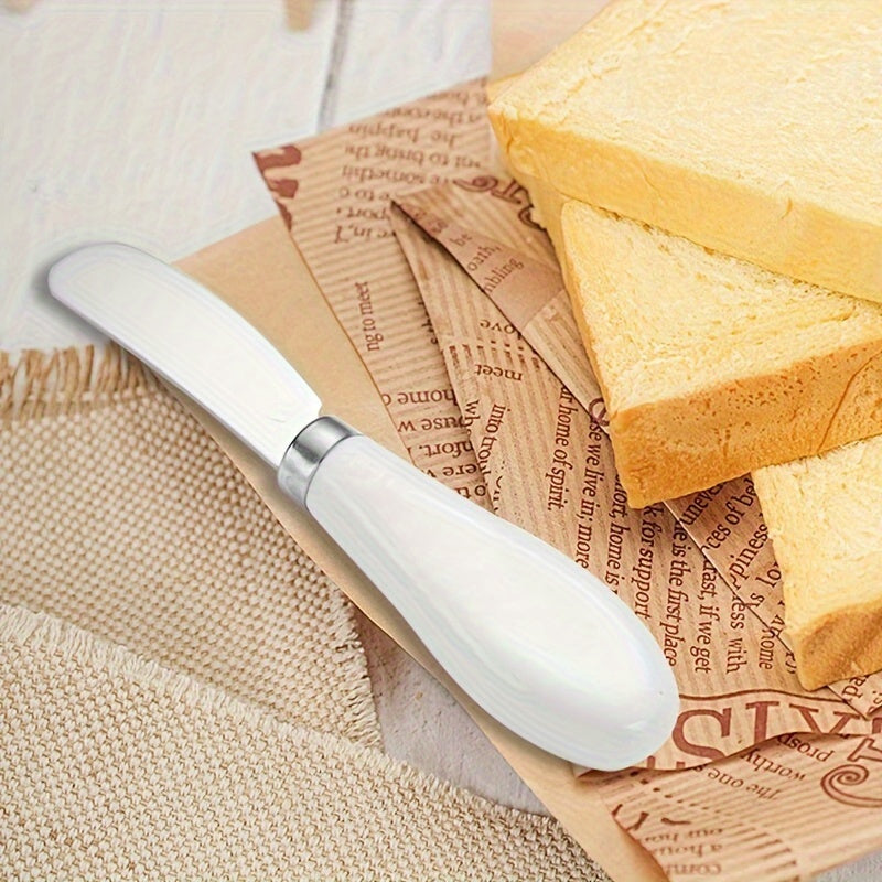 Stainless steel cheese knife set with ceramic handles for spreading butter, jam, cream, and cutting bread or cake.