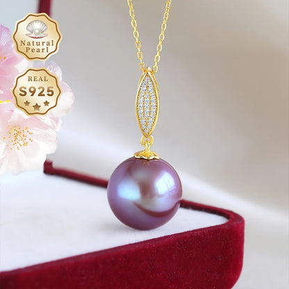 This stunning pendant necklace features a 13-14mm round natural freshwater pearl in an elegant shade of purple. The gemstone may have minor imperfections, adding to its unique beauty. The pendant is crafted from S925 silver and comes with a gift box