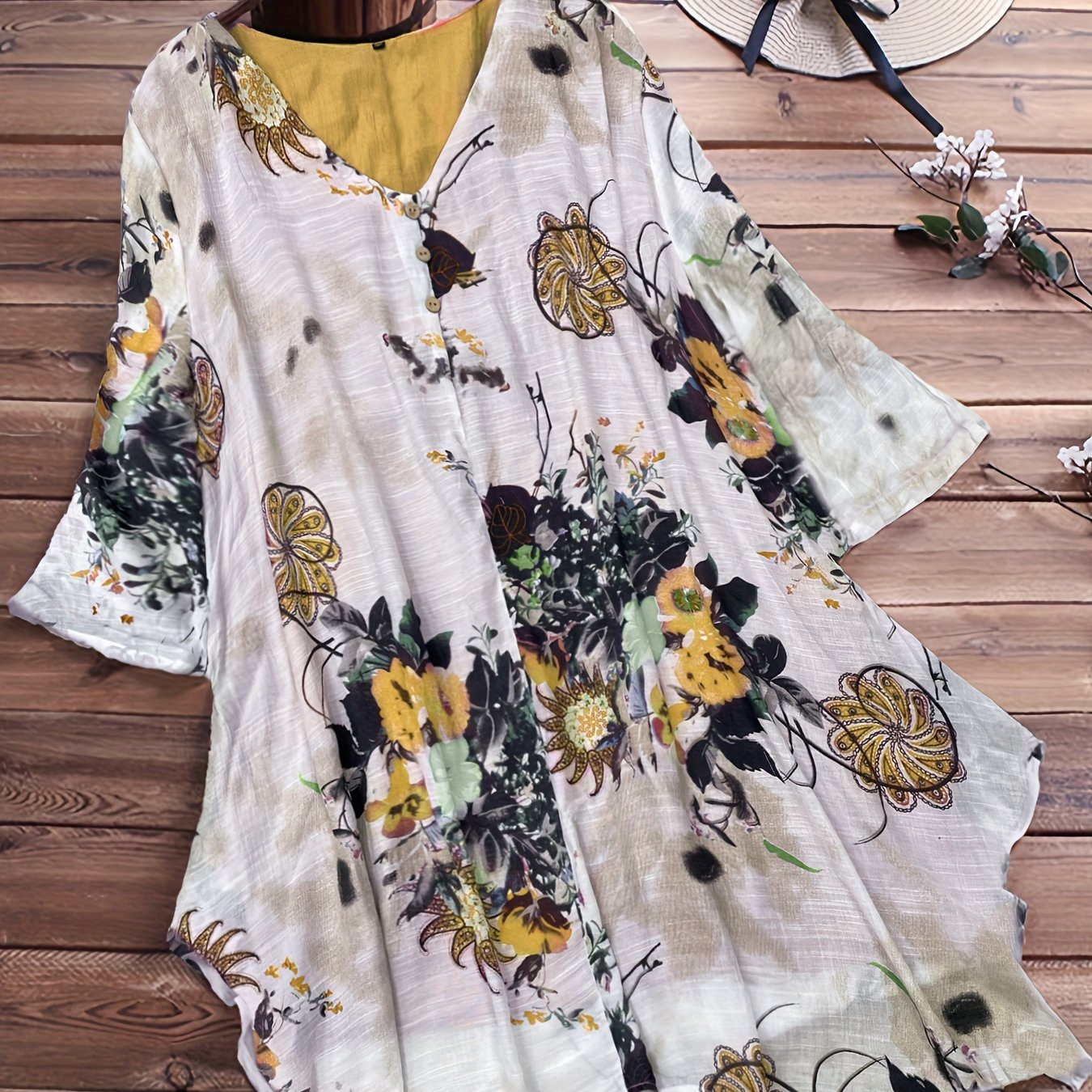 Women's plus size casual top with floral print, short sleeves, V-neck, and asymmetrical hem.