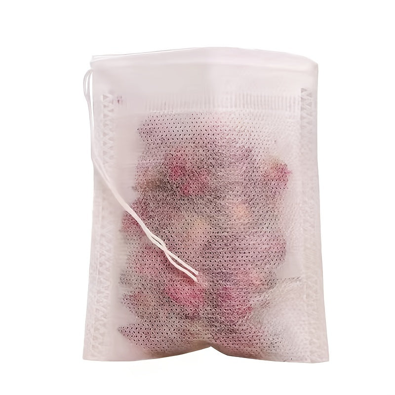 100 pieces of disposable tea filter bags made of plastic with drawstring, designed to be filled with loose leaf herbs and spices for infusion.