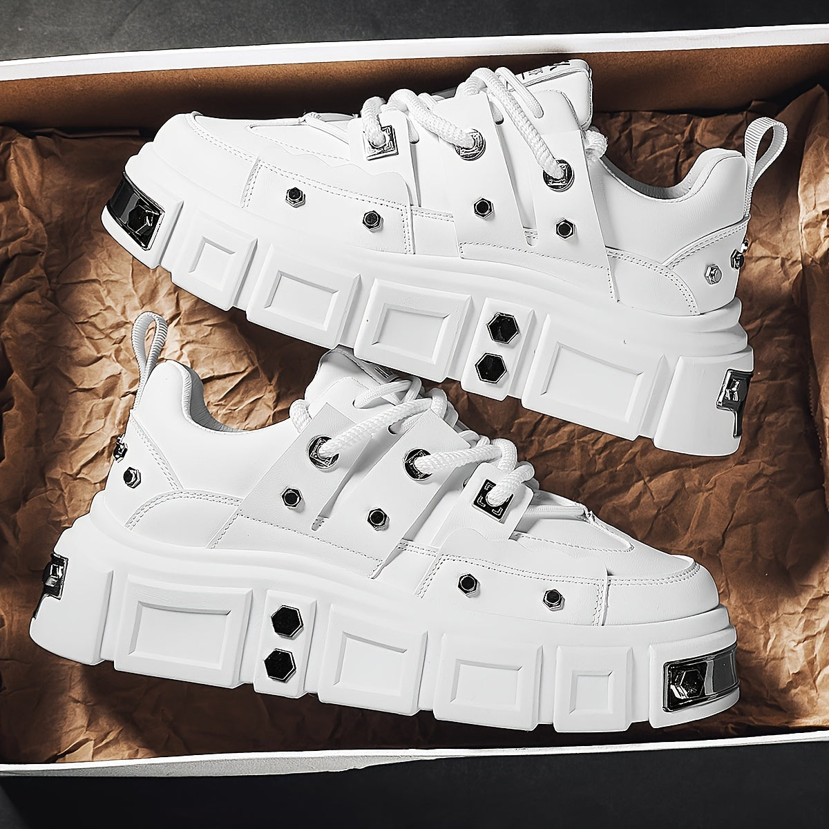 Chunky, punk-inspired sneakers with metal stud accents. Streetwear fashion statement in white, thick-soled trainers. Ideal for skateboarding, parties, and everyday wear. Unisex.