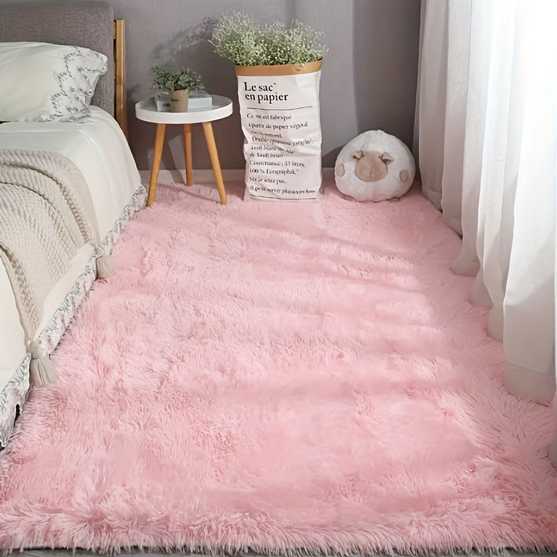 This solid pink polyester area rug is both fluffy and durable, making it perfect for any room in your home or office. The non-slip backing ensures safety, while the stain-resistant material is easy to clean with dry cleaning. This machine-made