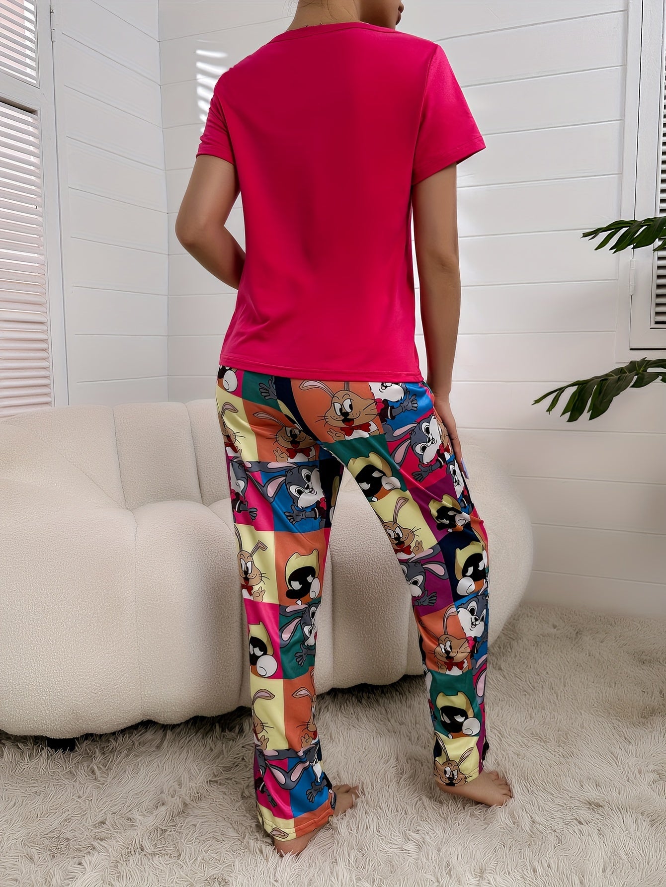 Women's cute cartoon print pajama set with short sleeve top and pants, featuring a comfortable relaxed fit.