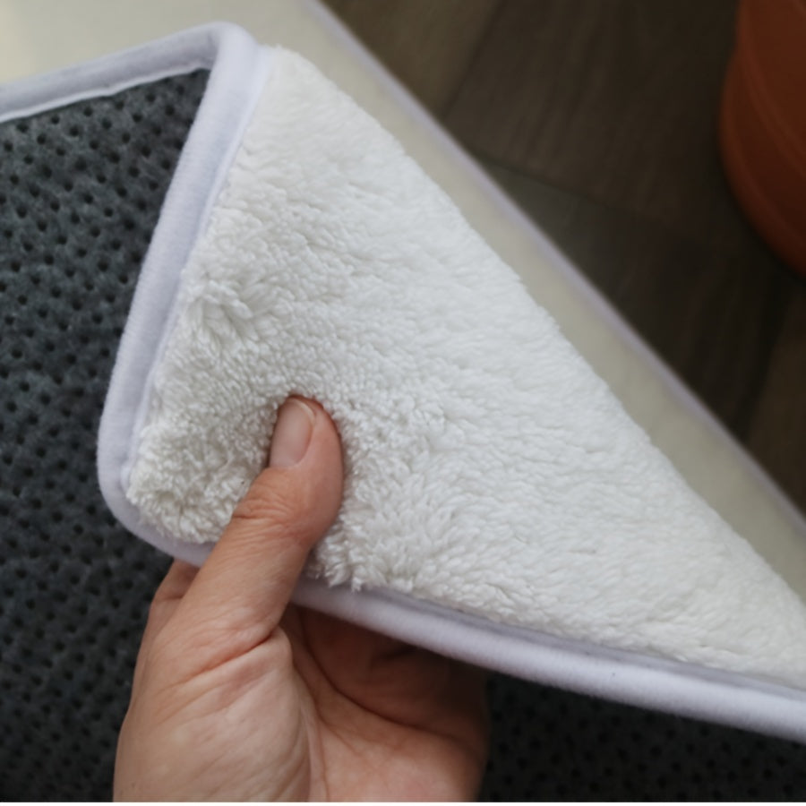 Machine-made oblong bath rug made from quick-dry absorbent knit fabric with non-slip features. Crafted from polyester fiber, this rug is 1.8cm thick and has a weight of 780gsm. Suitable for entryways, bedrooms, living rooms, and garages. Easy to care for