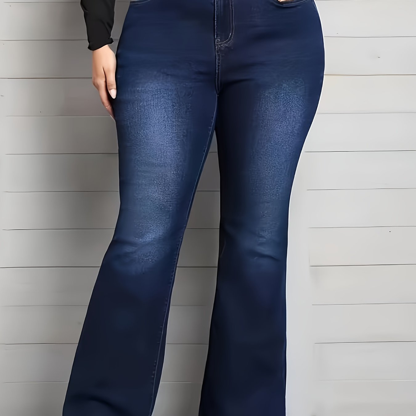 Women's plus size blue flare jeans made of stretch denim with a classic button closure, perfect for casual wear.