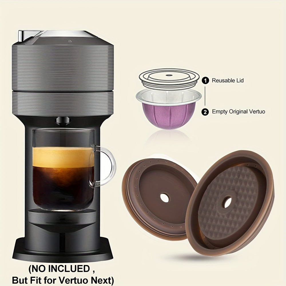 One pack of two reusable coffee capsule lids compatible with Nespresso Pods Vertuo, made of food grade silicone. These caps fit all sizes of reusable Nespresso Vertuo pods and come with a scoop and brush for easy refill.