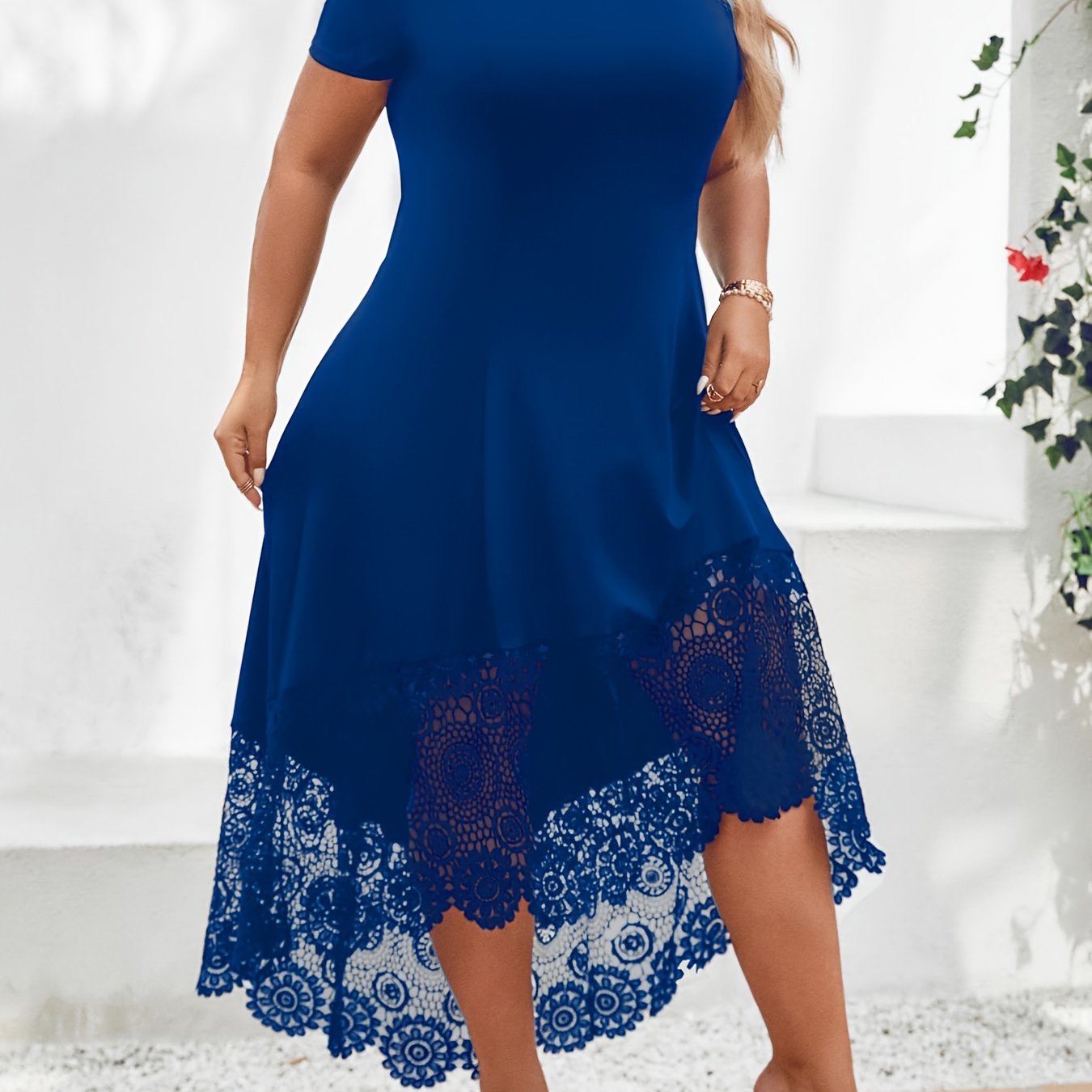 Stylish plus size black dress with white lace panel features off-shoulder design, short sleeves, and asymmetrical hem. Made of medium stretch, machine washable fabric, this dress is ideal