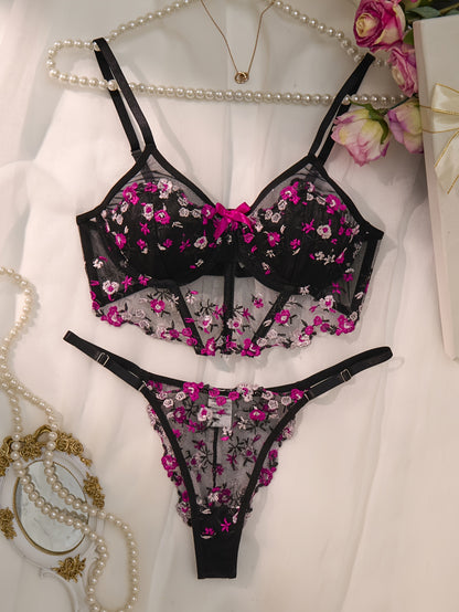 Stylish black lingerie set with floral embroidery, sheer mesh bra, low-rise thong, intricate back detailing, ideal for parties and everyday wear.