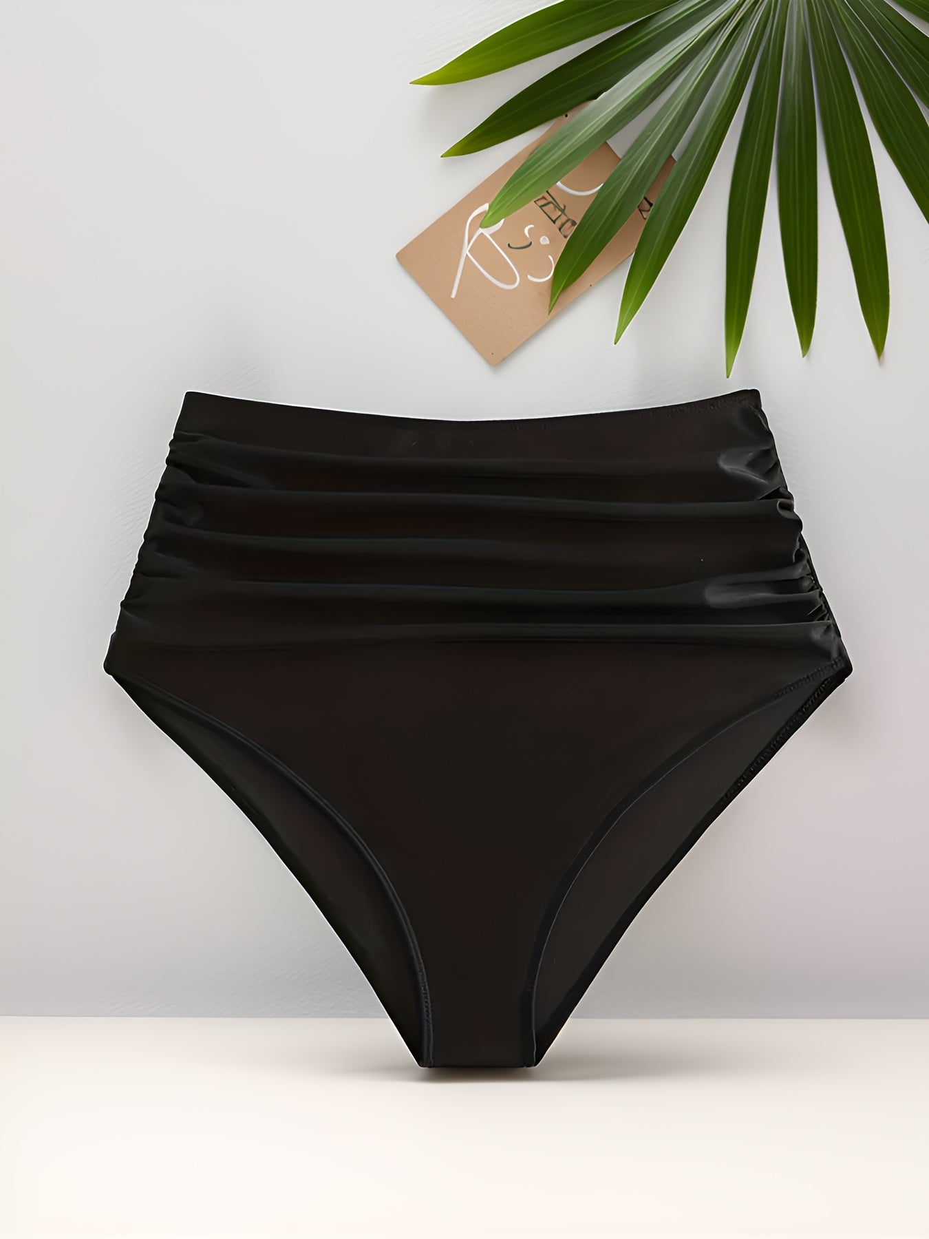 Stylish high-waisted swim bottoms for women made of a polyester and elastane blend. Features frill detail, solid color, high stretch, and knit fabric.