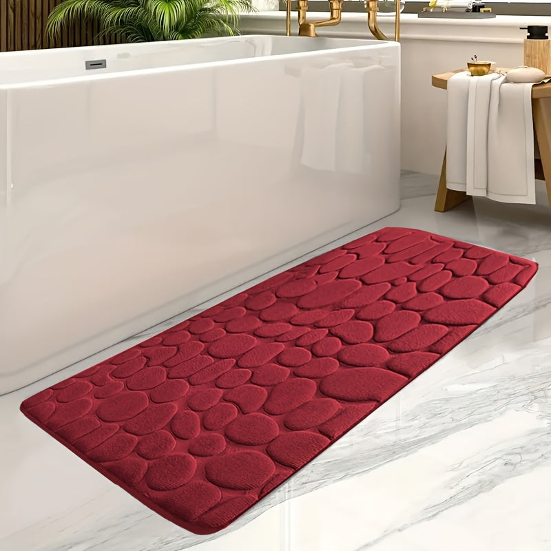 Soft coral fleece memory foam bath mat with geometric design, non-slip and absorbent. Machine washable polyester rug for bathroom and entryway decor.