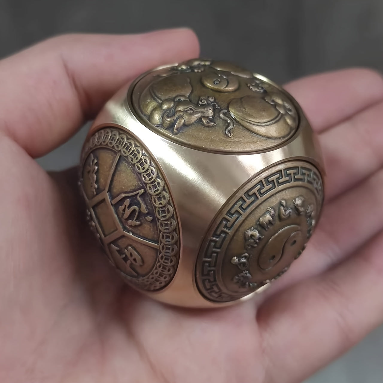 Brass stress relief sphere for prosperity and good fortune.