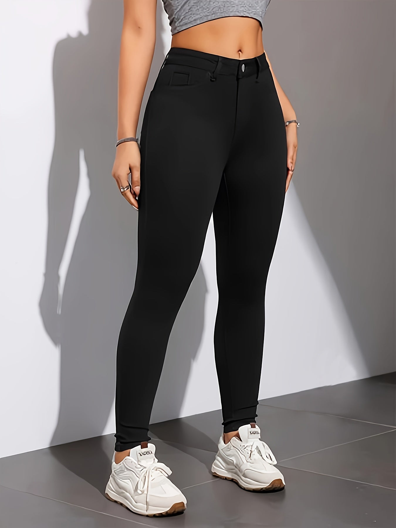 High-waist, skinny jeans in chic black with casual stretch denim, solid color, long length, trapeze hem, and zipper fly. Suitable for all seasons.