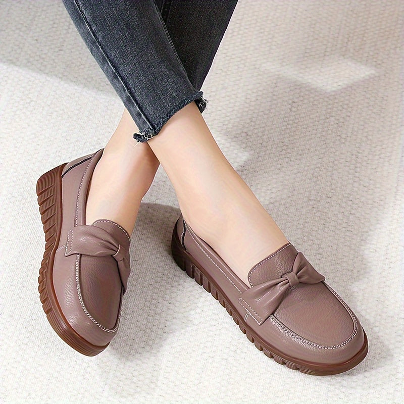 Women's comfortable penny loafers with bow embellishment, non-slip sole, round toe, all-season footwear, man-made materials, TPR sole.