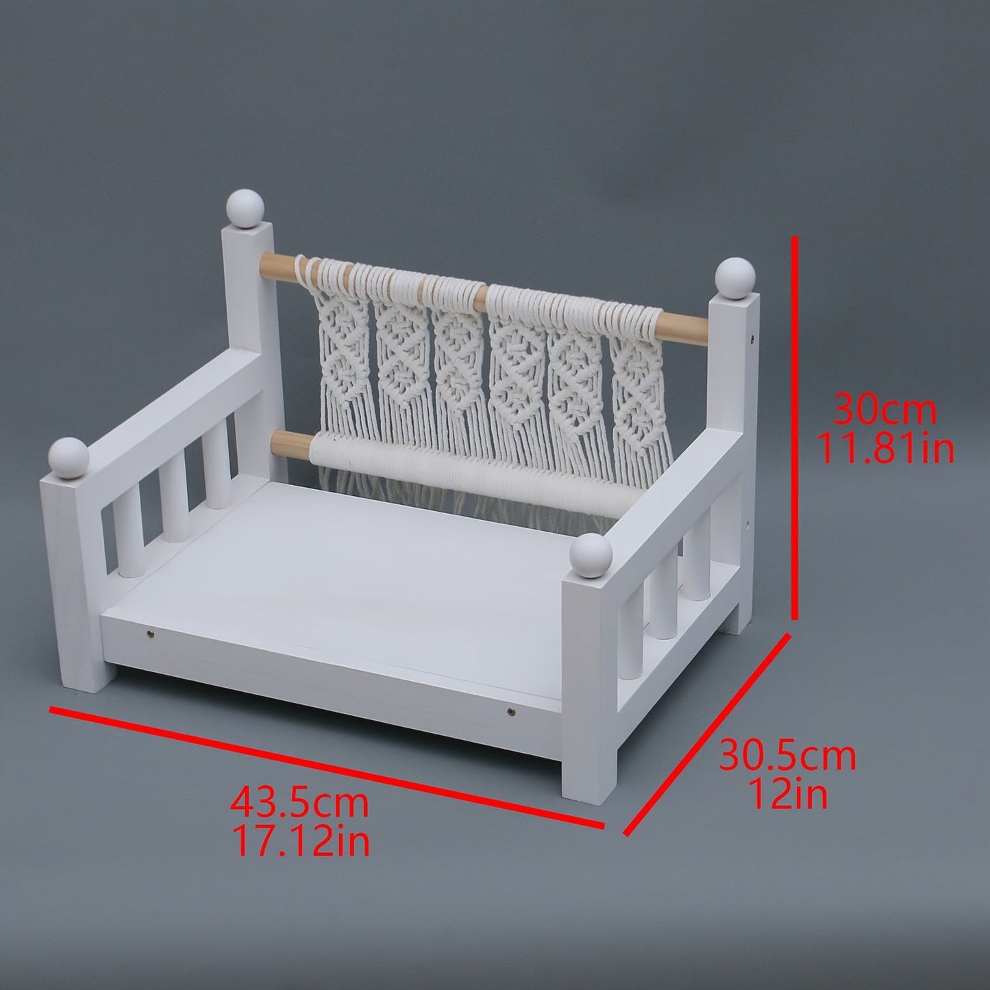 Photography props for baby photos include a white wooden crib bed.