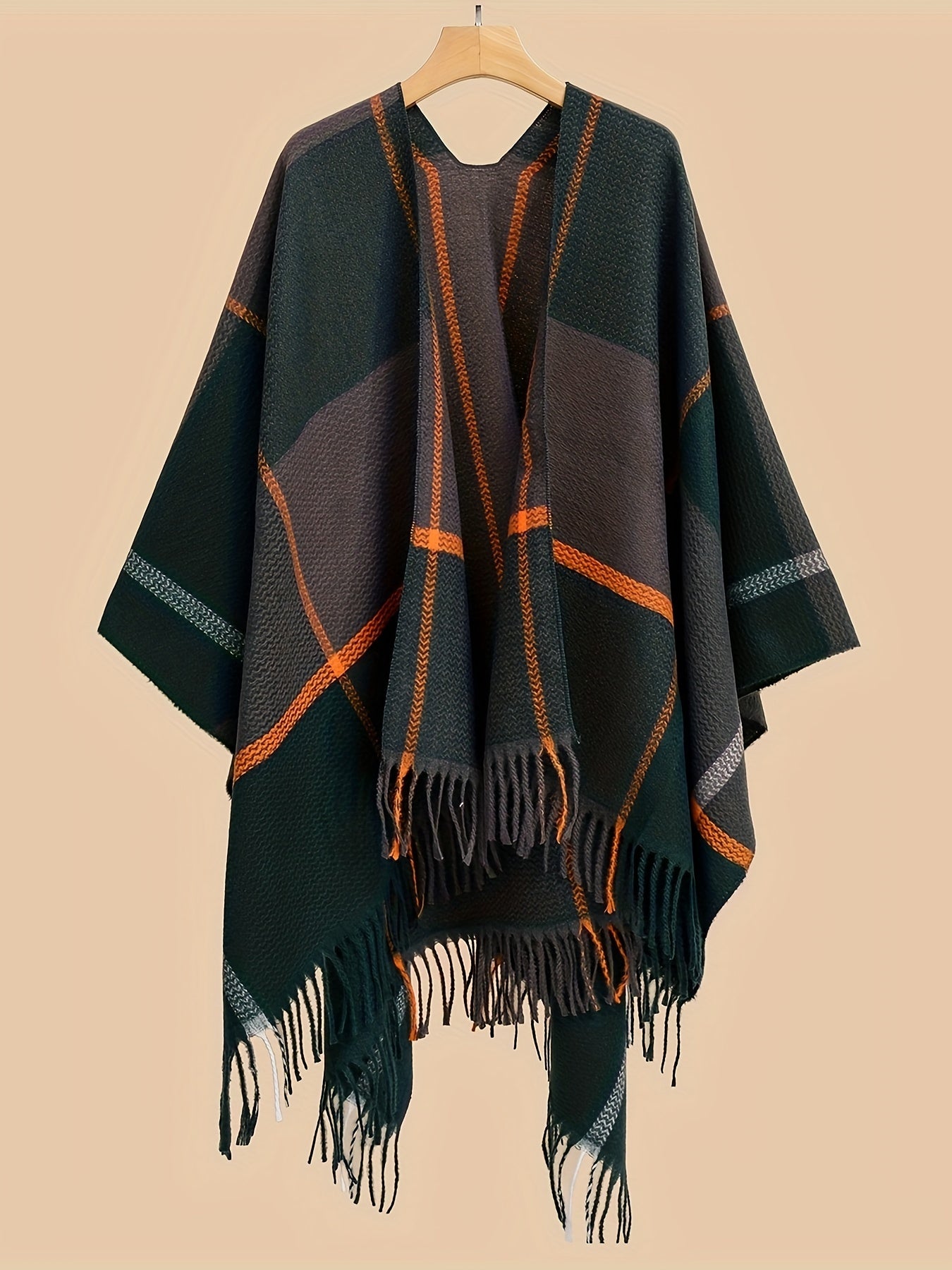 Stylish plus size shawl cardigan with tassels for fall/winter parties features v-neck, asymmetrical hem, and geometric pattern.