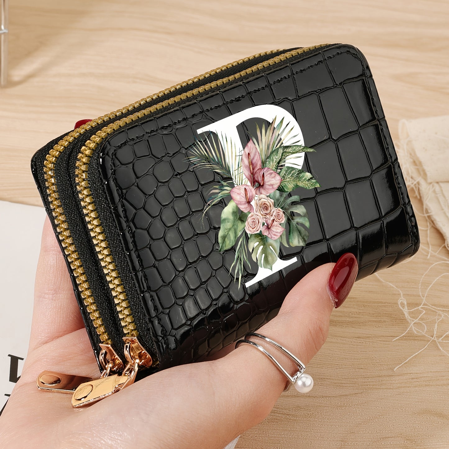 Women's credit card wallet with elegant floral letter print in black & white. Features large capacity, dual zipper, crocodile texture PU, lightweight design with nylon lining for everyday