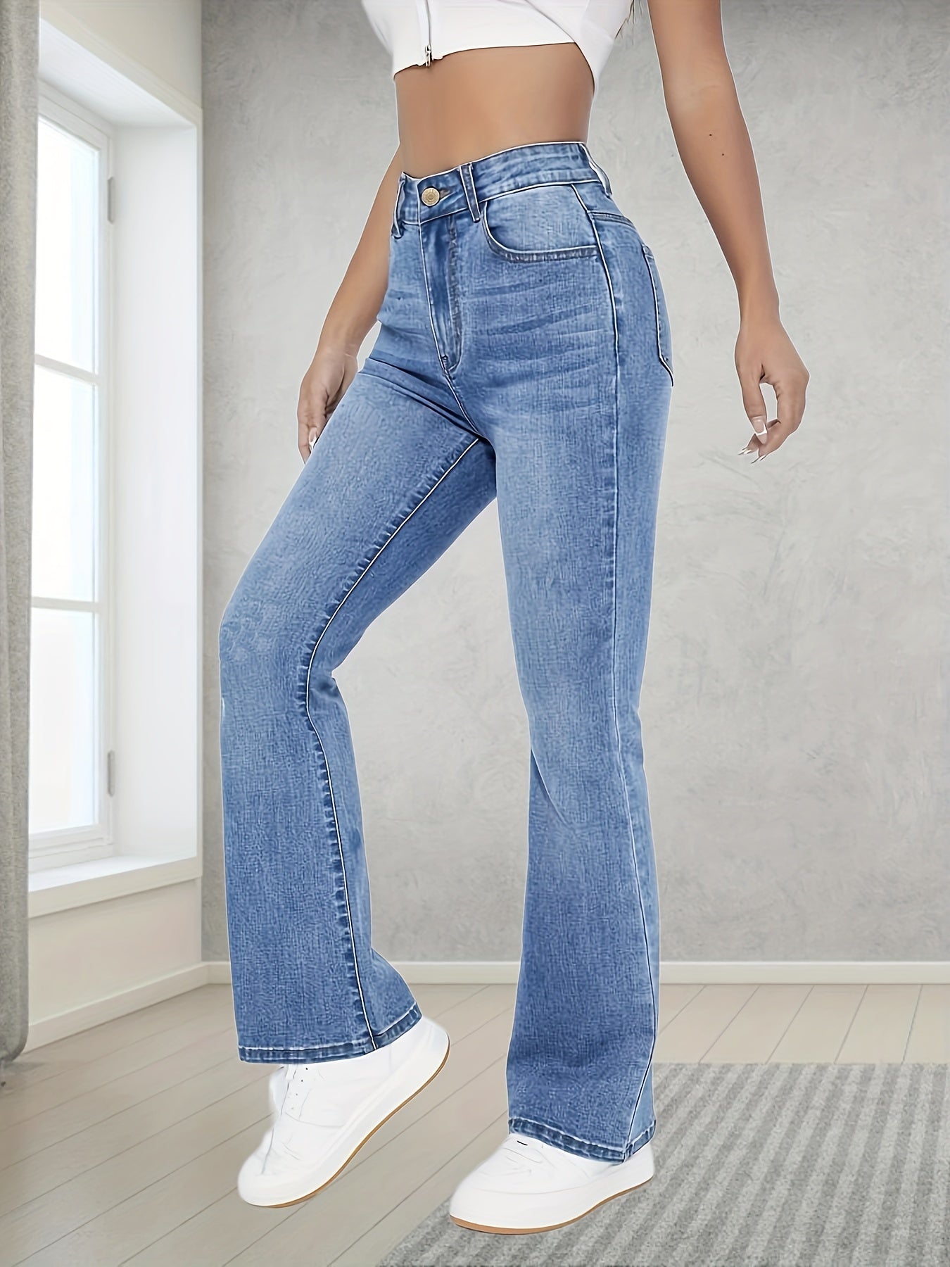 Washed blue flare leg jeans with stretch, slant pockets, and bell bottom design for women.