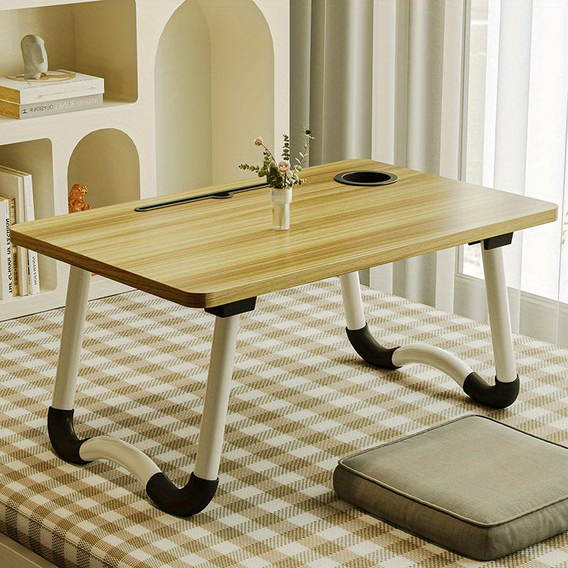 Foldable laptop desk with sturdy material and spacious desktop, suitable for student dorms.