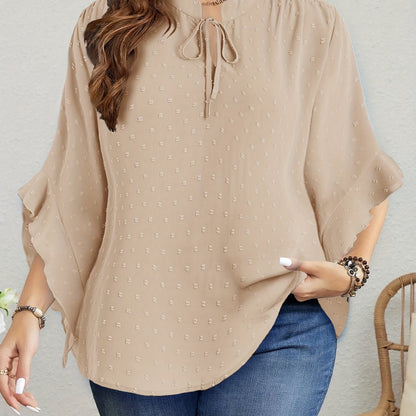 Stylish beige Swiss dot blouse with ruffle trim, tie-neck, and long sleeves. Machine washable and perfect for fall. Vintage style for women.