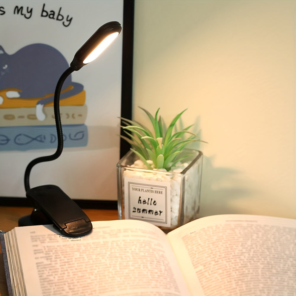 Portable battery-powered space-themed book light with adjustable arm, push button control, and uplight lighting, ideal for bedside use.