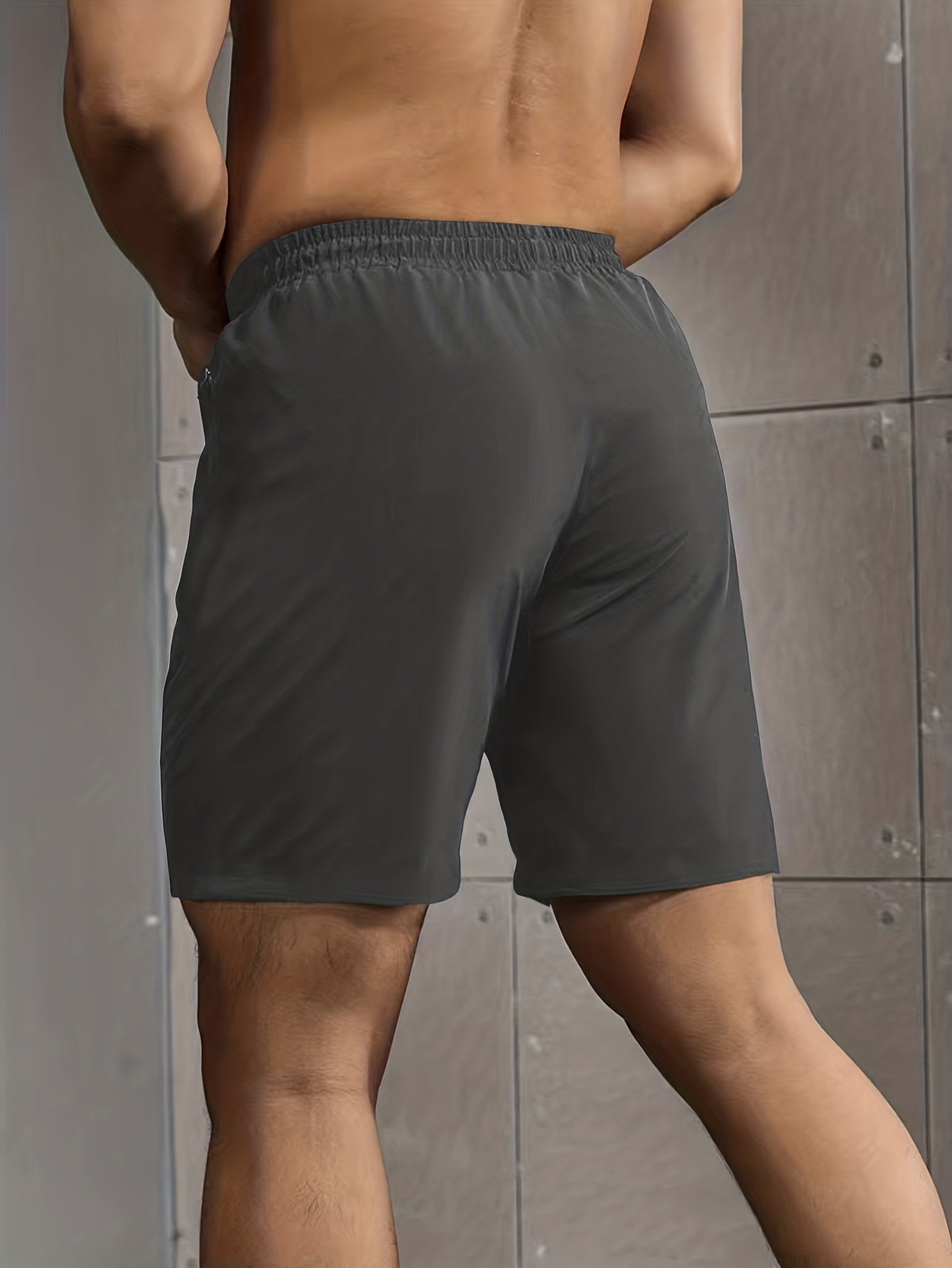 Men's casual style shorts with zip pockets, drawstrings, and performance letter print, ideal for summer outdoor activities.