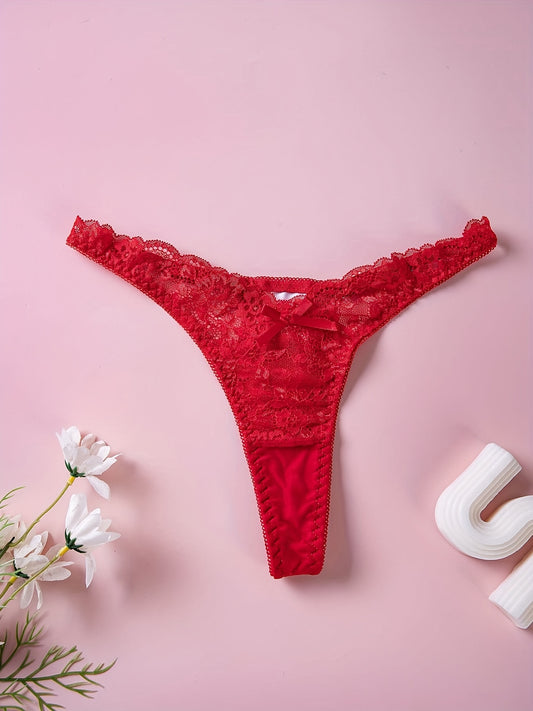 Red lace thong panties with floral print and bow detail, low rise V-shaped design. Made of breathable polyester blend, hand washable. Ideal for intimate moments.