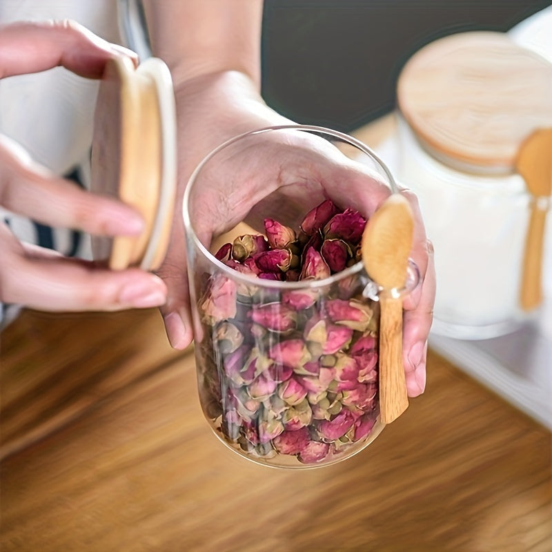 Glass airtight jars with bamboo lids and wooden spoons are versatile round food storage containers for the kitchen. They are reusable, easy to hand wash, and feature a flip top closure. Perfect for storing sugar, spices, and dry goods.