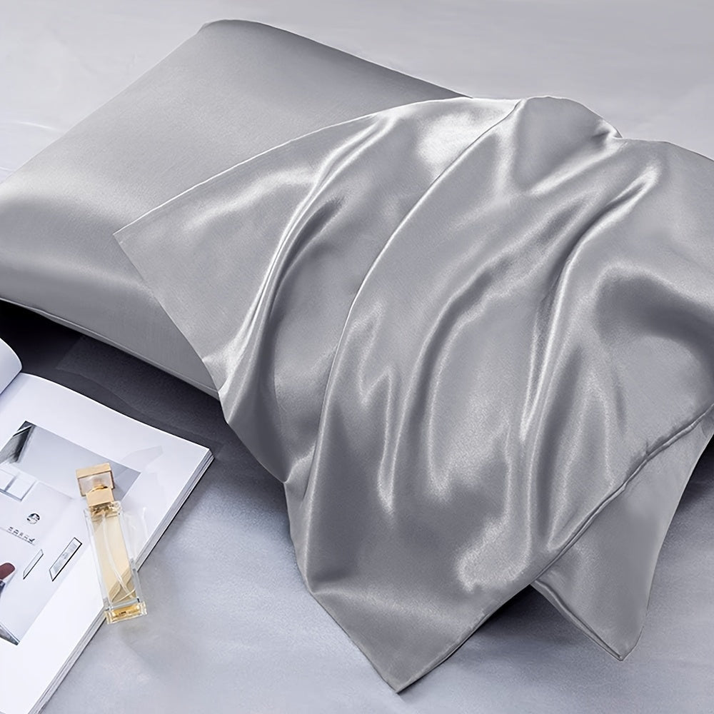 Two-pack of luxurious silky satin pillowcases, made from ultra soft smooth polyester with an envelope closure design. Available in solid colors, these machine washable pillow covers are lightweight at 80-85gsm, providing cooling comfort for hair and