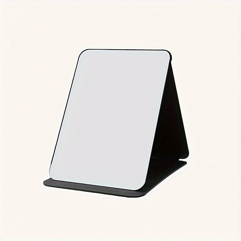 Stylish black foldable makeup mirror, great for desk, bedroom, and bathroom decor. Ideal for travel and makes a unique gift for weddings, parties, and birthdays. Glass surface with polished finish.