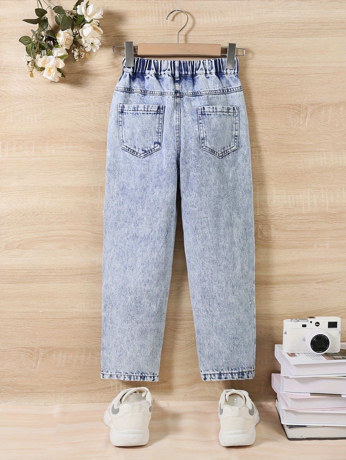 Girl jeans are stylish and versatile for all seasons, with specially designed holes for a trendy look.