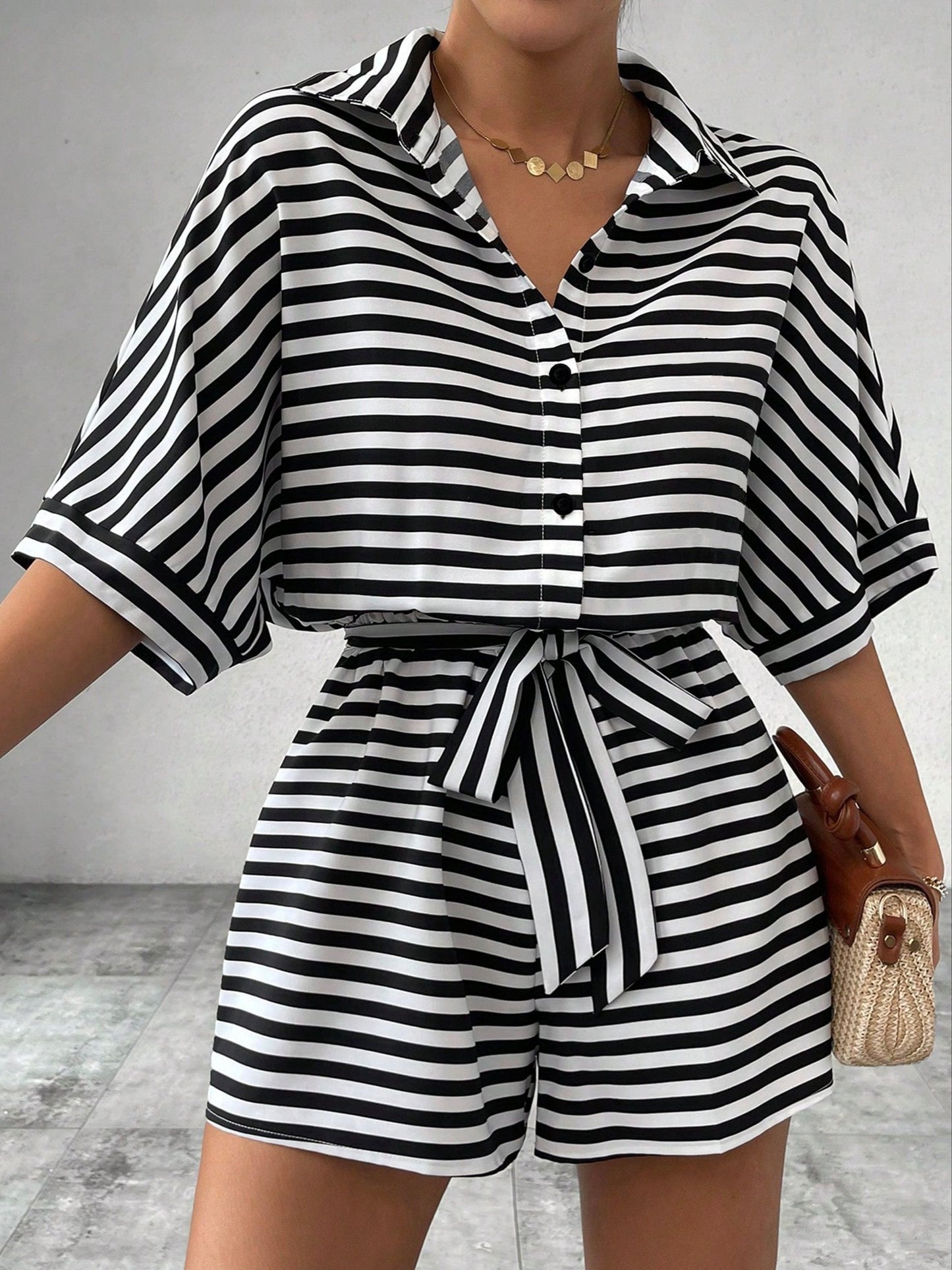 Button front romper jumpsuit with stripes, belt, short sleeves for spring and summer.