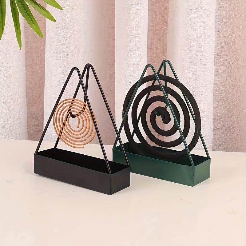 Sleek black metal mosquito coil holder with triangular design incense burner and wooden spiral insert. Ideal for home decor and indoor air freshening. Unsceted and made of metal for a modern touch.