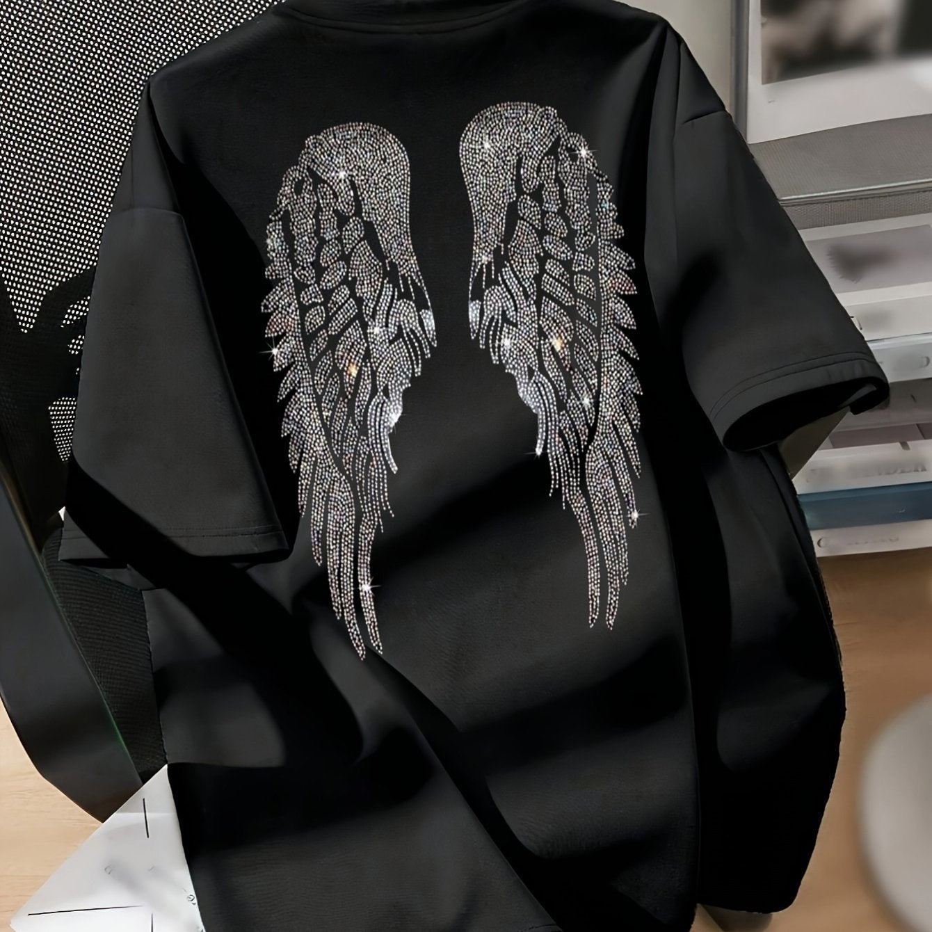 Casual black t-shirt with intricate wing design, short sleeve, crew neck, stretchy polyester blend, machine washable - ideal for spring and summer.