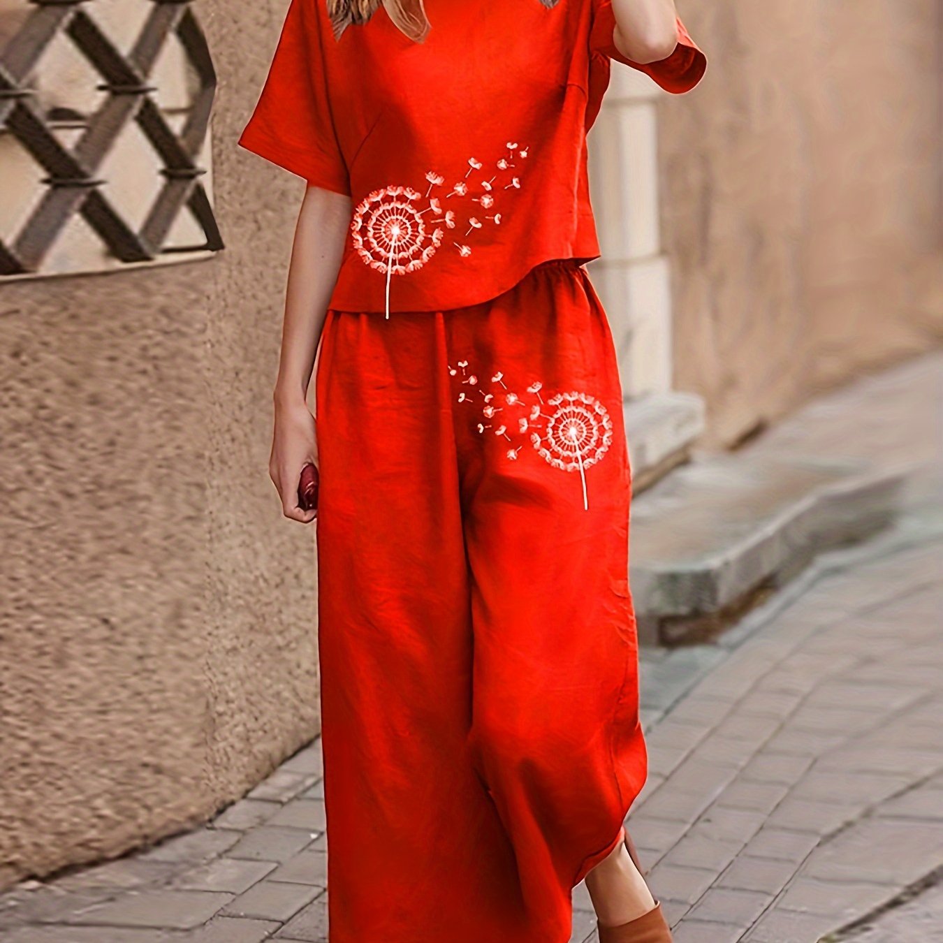 Boho dandelion print pajama set for women with loose fit, short sleeve top, and wide leg cropped pants.