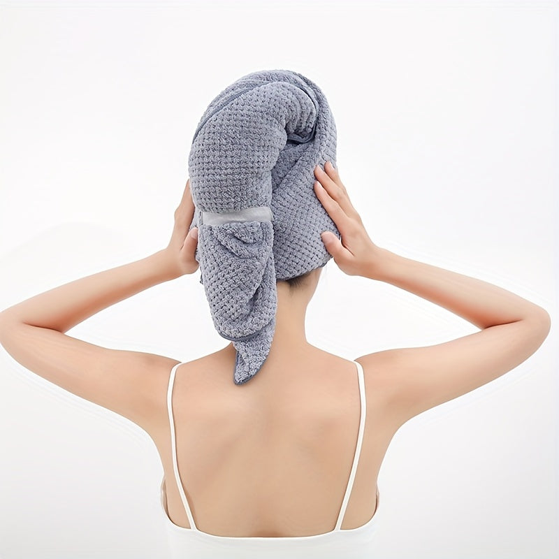 Fast-drying microfiber hair towel for women with long, thick, and curly hair. Soft coral fleece material with elastic band for everyday comfort. Beige textured design for quick drying.