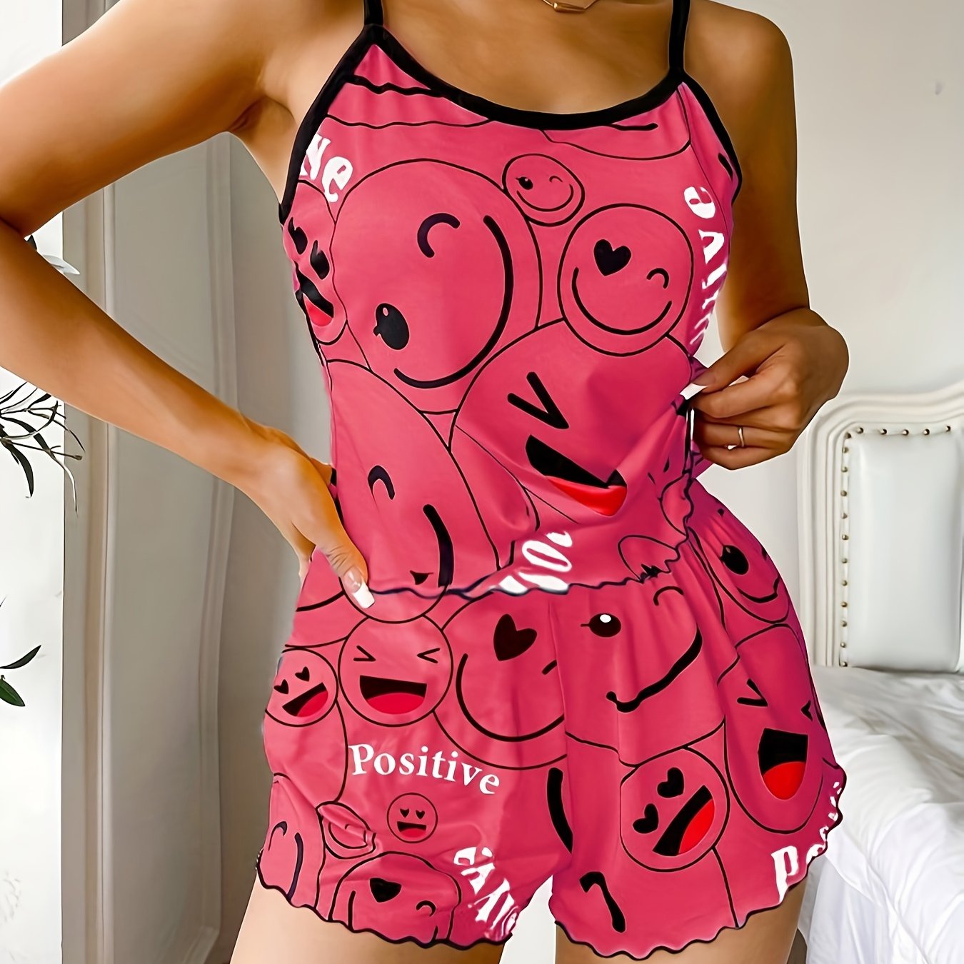 Women's sleepwear set with smiling face print cami top and elastic shorts.