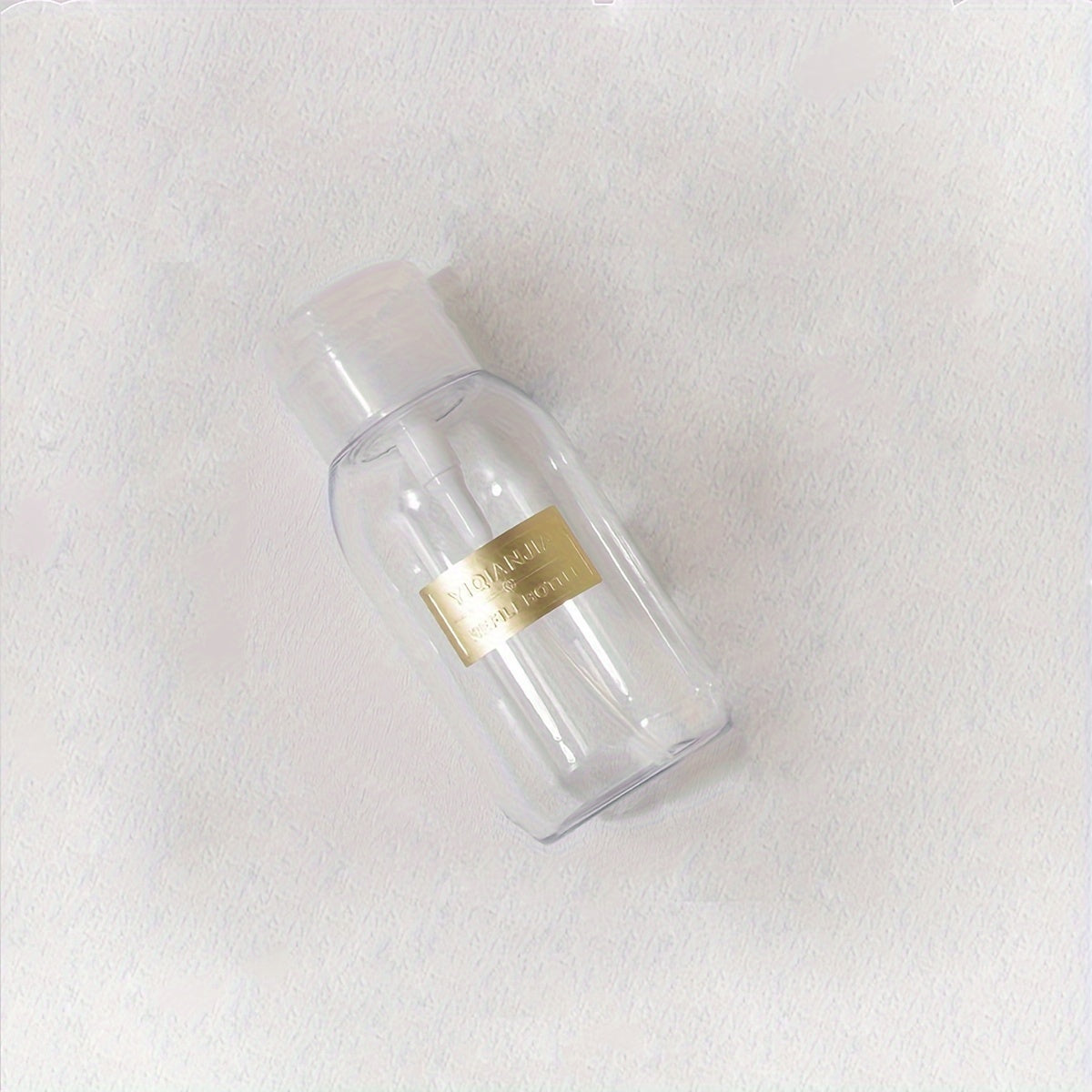 A portable push down empty bottle for dispensing nail polish or makeup remover.