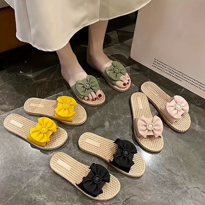 Women's PVC slip-on sandals with bow and bead accents, flat heel, open toe, ideal for beach wear.  Bow embellished, made from synthetic material.