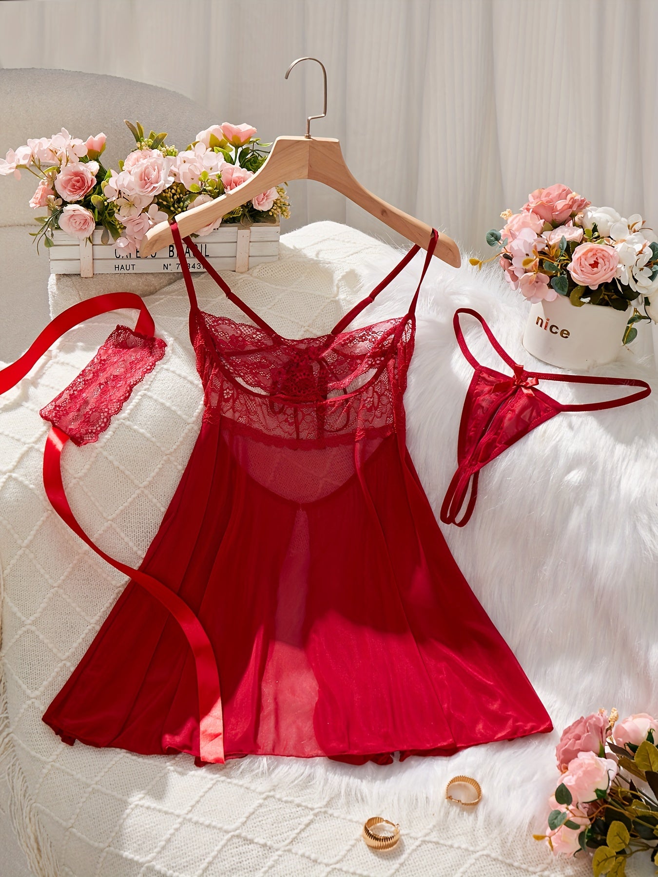 Red lingerie set featuring babydoll dress, G-string panty, eye mask, lace detail, satin ribbon accents - perfect for seductive boudoir attire.