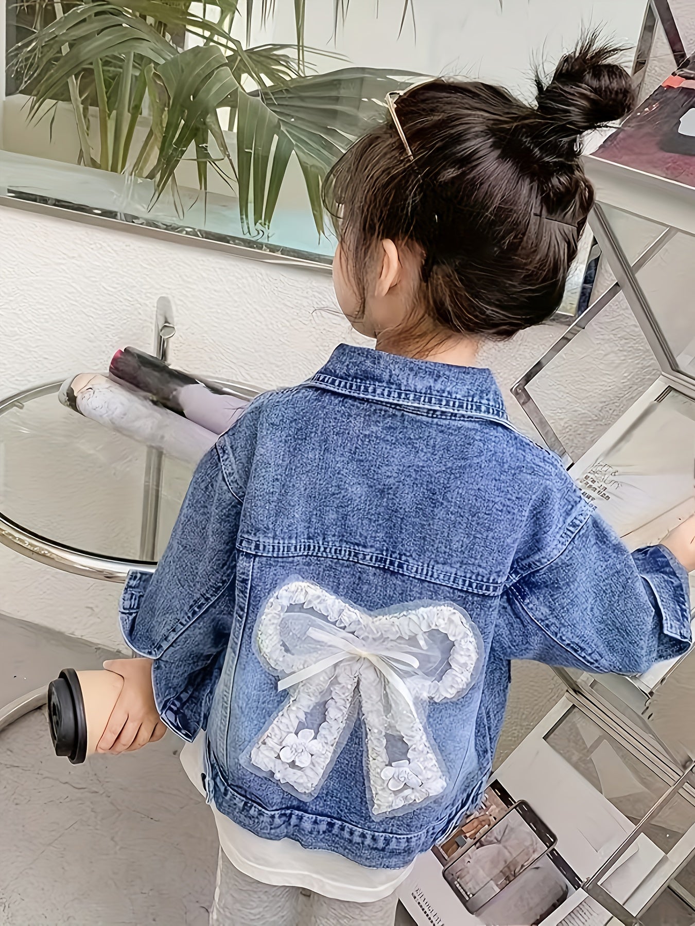 Children's loose fit denim jacket for girls, made from soft fabric.