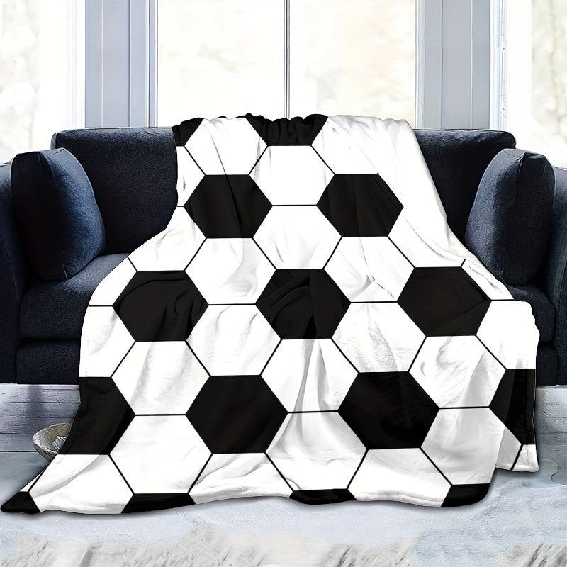 Soft and cozy football-themed blanket for kids made of flannel, featuring a hexagonal black and white soccer ball pattern. Perfect for bed, sofa, travel, and camping. Ultra-soft, lightweight, and warm. Machine washable. Ideal for both bed and sofa.