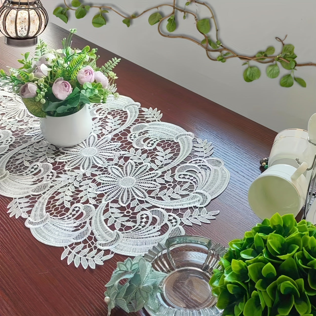 White velvet lace oval table runner with floral pattern, perfect for holiday table setting. Butterfly motif on decorative fabric for dining and home decor.